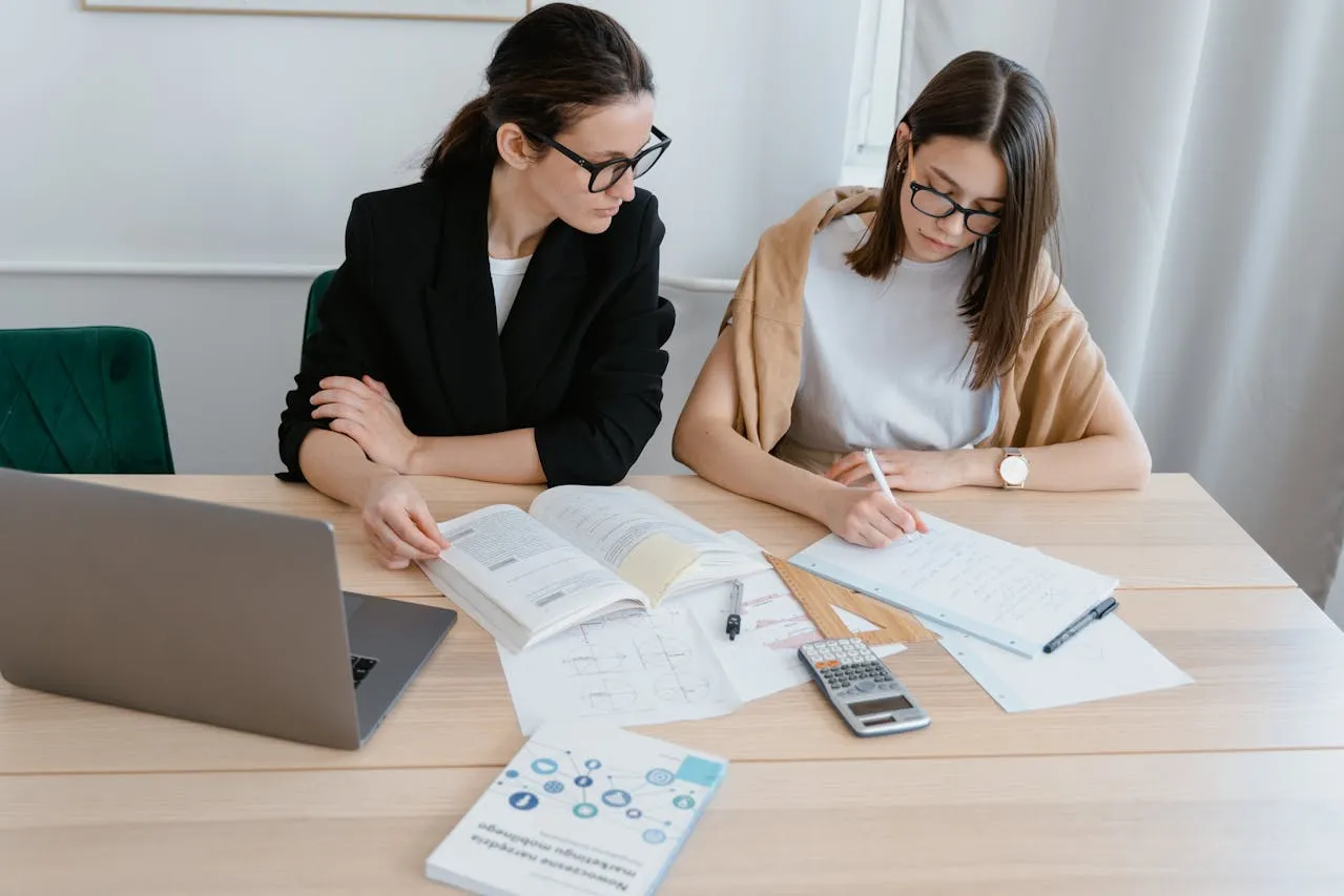 ACCA professional level exam preparation with notes and laptop)