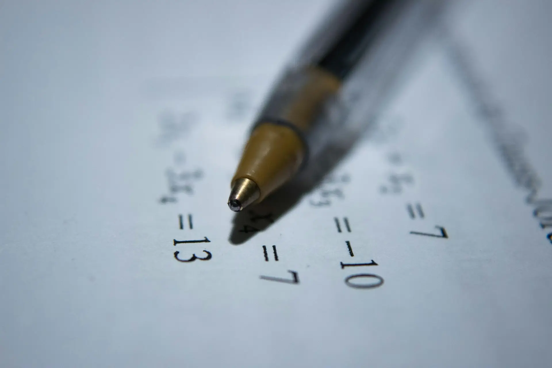 An image shows a student working on written exam papers, illustrating the focus on paper-based study relevant for acca f1 past papers preparation